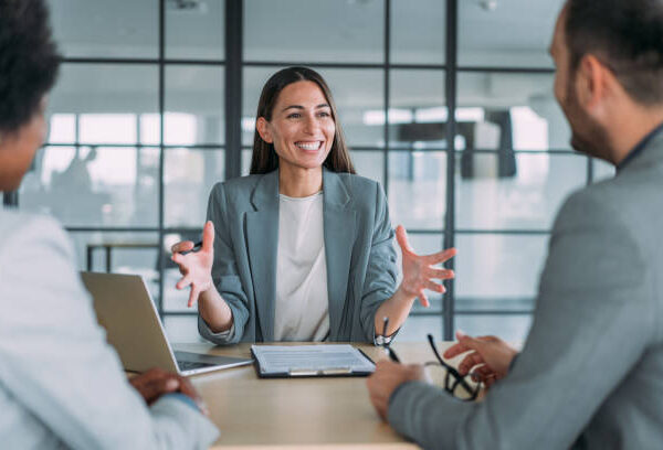 Shot of group of business persons in business meeting. Three entrepreneurs on meeting in board room. Corporate business team on meeting in modern office. Female manager discussing new project with her colleagues. Company owner on a meeting with two of her employees in her office.